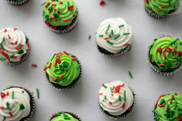 Green and white iced cupcakes from above with sprinkles on